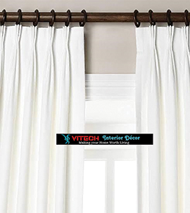 Plain white plitted pinched curtain