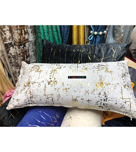 White lumbar pillow with gold prints